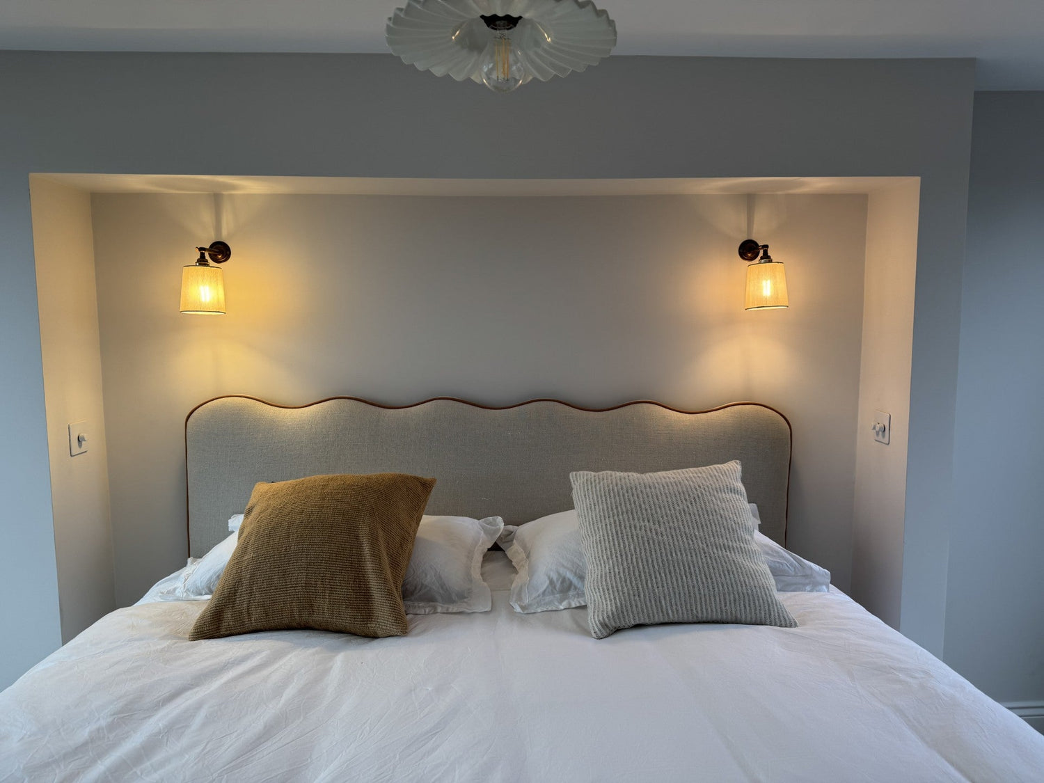 Provence headboard made with scallops stripe fabric with plain matching piping. 